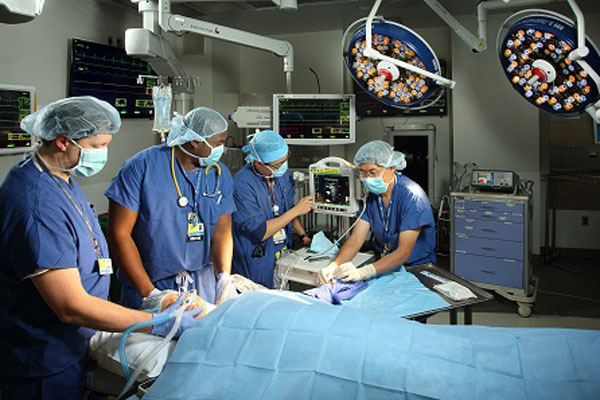 Johns Hopkins University surgeons performing a complex surgery in an operating room. Bonaventura Neurosurgical Award.
